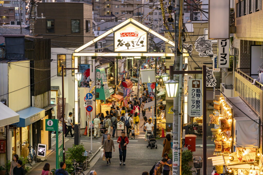 Yanaka Ginza, a shopping street crowded with people snacking on the go.
